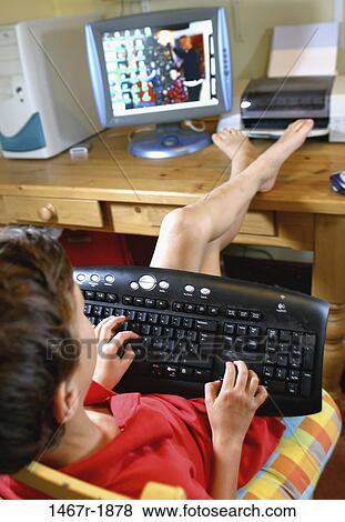 people, desk, keyboard, computer, typing, boy, relaxing View Large Photo Image Stock Photo - people, desk, keyboard, computer, typing, boy, relaxing. Fotosearch