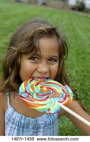Stock Photo - people, eating, Hispanic, candy, girl, child, brunette. Fotosearch