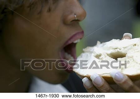 people, eating, woman, bagel, holding, outdoors View Large Photo Image Stock Image - people, eating, woman, bagel, holding, outdoors. Fotosearch