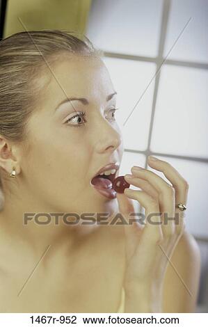 Stock Image - people, eating, woman, grape, fruit, blond, food. Fotosearch