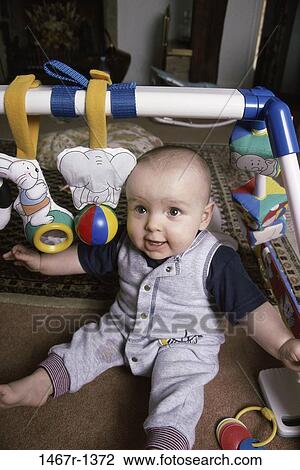 Stock Image - people, excitement, excited, baby, curious, toy. Fotosearch