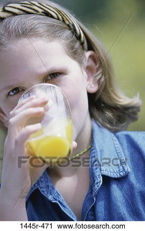 Stock Image - people, glass, orange juice, drinking, girl, outdoors, child. Fotosearch