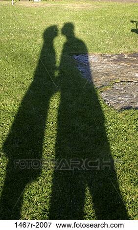 Stock Photo - people, shadows, couple, outdoors, romantic, romance. Fotosearch