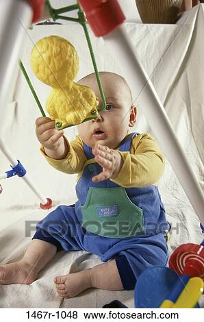 people, sitting, baby, boy, curious, reaching, toy View Large Photo Image Stock Photo - people, sitting, baby, boy, curious, reaching, toy. Fotosearch