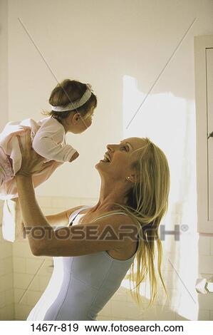 Stock Photo - people, smiling, playing, mother, baby, earring, laughing. Fotosearch