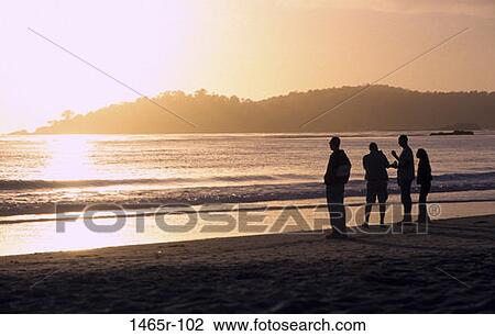 people, talking, ocean, sunset, beach, standing View Large Photo Image Stock Image - people, talking, ocean, sunset, beach, standing. Fotosearch