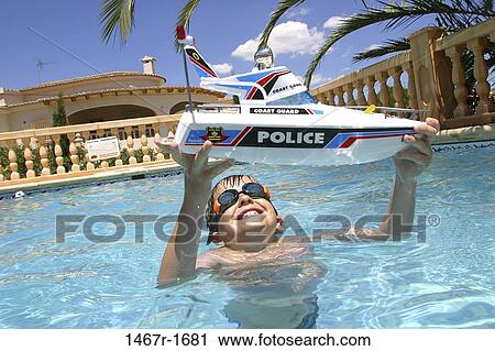 Stock Image - people, water, pool, smiling, playing, boy. Fotosearch