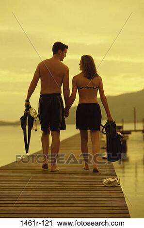 Stock Image - people, water, walking, couple, beach, sports, tourism. Fotosearch