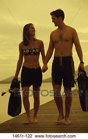people, water, walking, couple, beach, equipment, water sports View Large Photo Image Stock Image - people, water, walking, couple, beach, equipment, water sports. Fotosearch