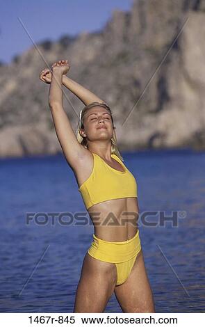 people, water, woman, smiling, beach, stretching, smile View Large Photo Image Stock Photography - people, water, woman, smiling, beach, stretching, smile. Fotosearch