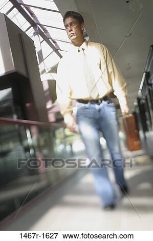 walking, briefcase, Hispanic, business, outdoors, serious, casual View Large Photo Image Stock Photo - walking, briefcase, Hispanic, business, outdoors, serious, casual. Fotosearch