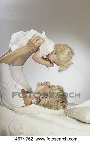 white, people, smiling, playing, pillow, mother, baby View Large Photo Image Stock Image - white, people, smiling, playing, pillow, mother, baby. Fotosearch