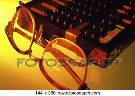 Stock Image - wisdom, eyeglasses, abacus, business, education, still life. Fotosearch