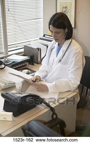 desk, woman, reading, doctor, chart, concentrating, health View Large Photo Image Stock Image - desk, woman, reading, doctor, chart, concentrating, health. Fotosearch