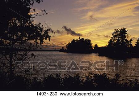 Stock Image - morning, dusk, evening, sunset, lake, calm. Fotosearch