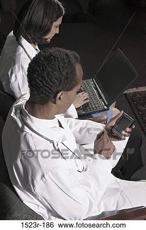 multiethnic, busy, computer, laptop, health, Middle-aged, using View Large Photo Image Stock Photograph - multiethnic, busy, computer, laptop, health, Middle-aged, using. Fotosearch