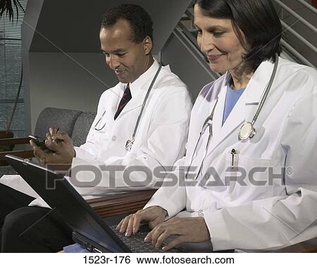 Stock Photograph - multiethnic, smiling, computer, laptop, typing, health. Fotosearch