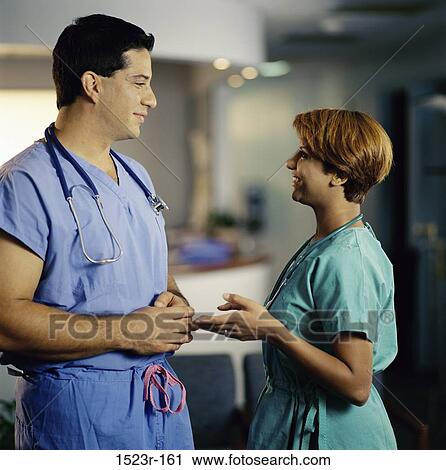 Stock Image - multiethnic, talking, discussion, conversation, health, Middle-aged, personnel. Fotosearch