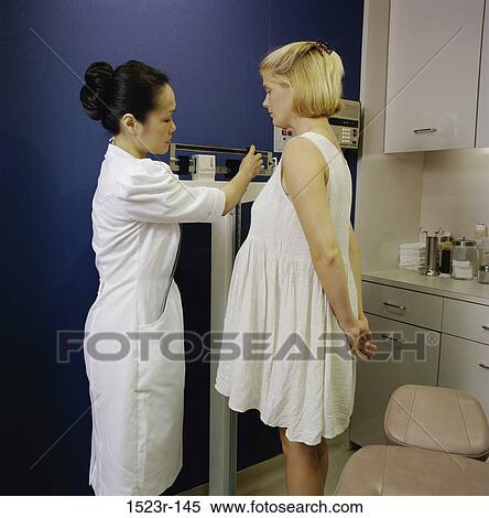 Stock Photography - multiethnic, women, patient, nurse, health, checking, weighing. Fotosearch
