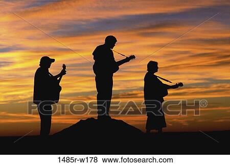 Stock Photo - people, boulder, music, sunset, guitar, silhouette. Fotosearch
