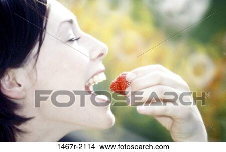 Picture - people, eating, woman, profile, healthy, strawberry. Fotosearch