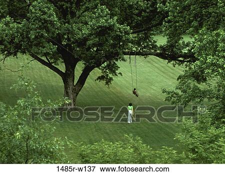 Stock Photo - people, green, mother, swinging, swing, outdoors. Fotosearch