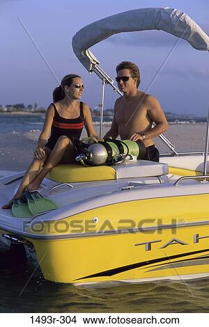 Picture - people, water, couple, beach, sunglasses, boating, sports. Fotosearch