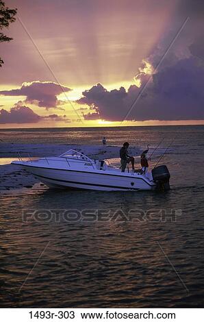 Stock Image - people, water, sunset, boating, outdoors, sports, boat. Fotosearch