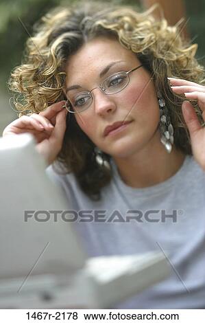 people, woman, eyeglasses, computer, concentrating, looking, brunette View Large Photo Image Stock Photo - people, woman, eyeglasses, computer, concentrating, looking, brunette. Fotosearch