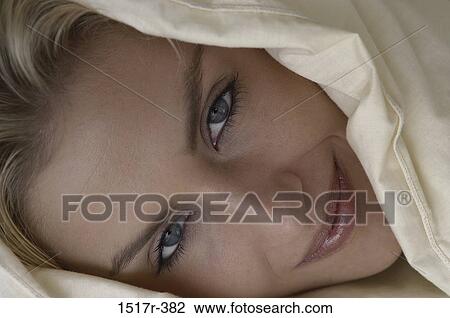 Stock Image - people, woman, smiling, bed, pleasant, smile. Fotosearch