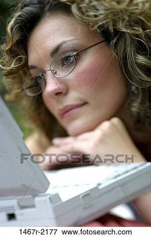 people, woman, staring, computer, reading, concentrating, brunette View Large Photo Image Stock Photo - people, woman, staring, computer, reading, concentrating, brunette. Fotosearch