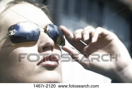 people, woman, sunglasses, outdoors, serious, blond View Large Photo Image Stock Image - people, woman, sunglasses, outdoors, serious, blond. Fotosearch