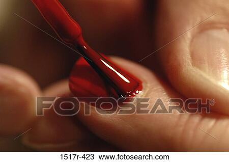 Stock Image - red, people, woman, painting, brushing, fingernails. Fotosearch