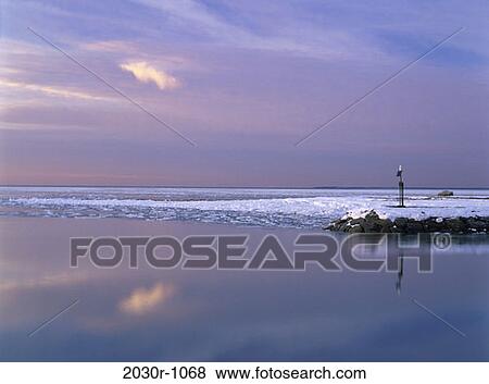 Stock Photo - snow, winter, sunset, lake, calm, nature, sunrise. Fotosearch