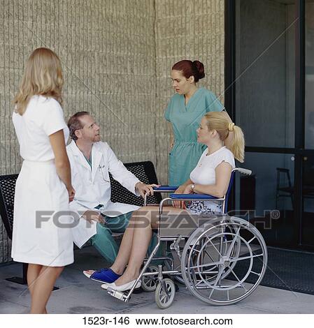 Stock Photograph - talking, conversation, patient, doctor, wheelchair, health, outdoors. Fotosearch