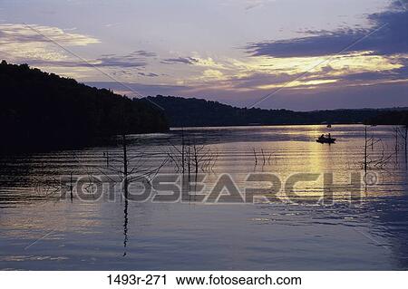 Stock Image - water, morning, lake, silhouette, sports, boat. Fotosearch