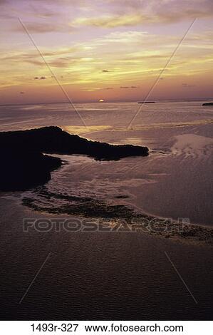 Stock Photo - water, sunset, beach, island, nature, aerial, sunrise. Fotosearch