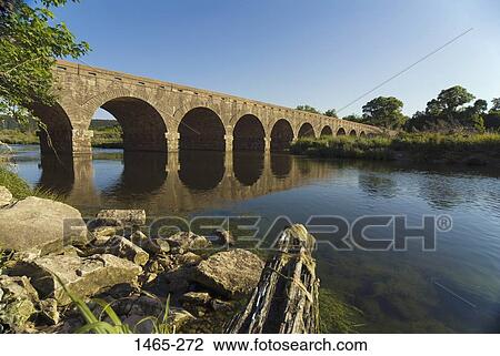 Stock Image - Arch bridge across a river, Brazos River, Texas, USA. Fotosearch