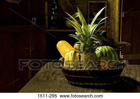 Stock Photography - Basket of tropical fruits on a table. Fotosearch