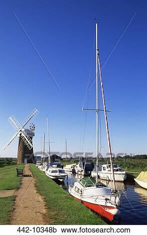 Boats moored near a traditional windmill, Horsey Windpump, Horsey, Norfolk Broads, Norfolk, England View Large Photo Image Stock Image - Boats moored near a traditional windmill, Horsey Windpump, Horsey, Norfolk Broads, Norfolk, England. Fotosearch