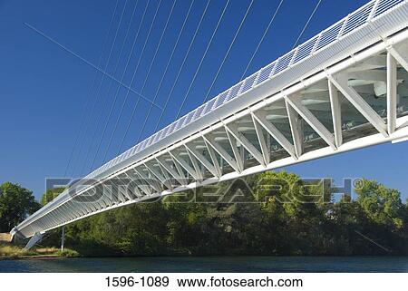 Stock Photo - Bridge across a river, Sundial Bridge, Turtle Bay Exploration Park, Redding, California, USA. Fotosearch
