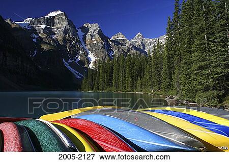 Stock Photo - Canoes in a row at the lakeside, Valley of the Ten Peaks, Moraine Lake, Banff National Park, Alberta, Canada. Fotosearch