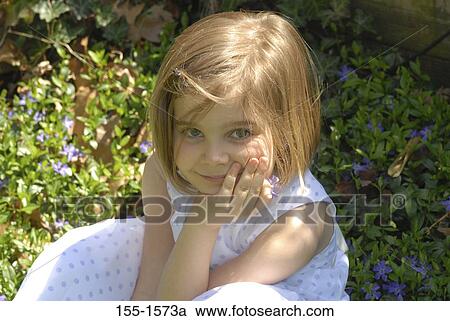 Close-up of a girl holding a flower View Large Photo Image Stock Image - Close-up of a girl holding a flower. Fotosearch