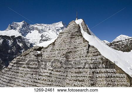 Stock Image - Close-up of text on a Mani stone, Kongde Ri, Sagarmatha National Park, Nepal. Fotosearch