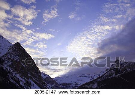 Clouds over snow covered mountains, Mount Victoria, Victoria Glacier, Banff National Park, Alberta, Canada View Large Photo Image Stock Photo - Clouds over snow covered mountains, Mount Victoria, Victoria Glacier, Banff National Park, Alberta, Canada. Fotosearch