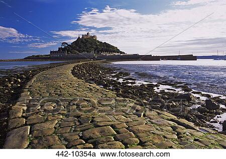 Stock Image - Cobblestone walkway leading towards an island, St. Michael's Mount, Marazion, Cornwall, England. Fotosearch