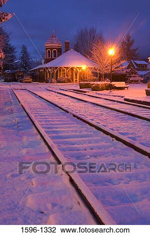 Stock Image - Depot and railroad tracks covered with snow, Northwest Railway Museum, Snoqualmie, Washington State, USA. Fotosearch