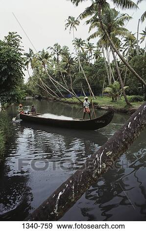 Stock Photo - Fishermen on a boat in a river, Kerala, India. Fotosearch