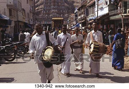 Four men playing Thavils the barrel shaped percussion instrument in a street, Tamil Nadu, India View Large Photo Image Stock Image - Four men playing Thavils the barrel shaped percussion instrument in a street, Tamil Nadu, India. Fotosearch