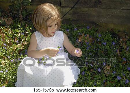 Girl picking up flowers View Large Photo Image Stock Image - Girl picking up flowers. Fotosearch